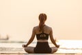 Back of views woman practice yoga lotus pose to meditation with summer vacation on the beach feeling so happiness and cheerful Royalty Free Stock Photo
