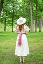 Back of vintage redhead woman with hat in park Royalty Free Stock Photo