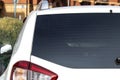 Back window of a white car parked on the street near houses, rear view. Mock-up for sticker or decals Royalty Free Stock Photo