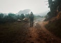 Back, winter hiking and a man in nature for freedom, travel or adventure in the mountain wilderness. Forest, morning and Royalty Free Stock Photo