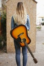 Back of a woman with acustic guitar Royalty Free Stock Photo