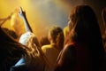 Back of woman in crowd, fan at concert or music festival watching rock event on stage. Girl in audience, excited fans at