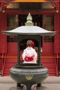 Woman in kimono praying in the shrine