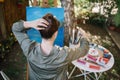 Back of woman making hairstyle while sitting in garden art studio Royalty Free Stock Photo