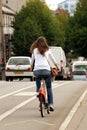 Back woman riding a bike in the city
