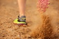 Back of woman shoe running on dirt road