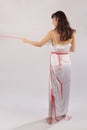 Woman white silk nightie pulling red thread on white background