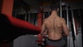 back workout in the gym. very power athletic guy bodybuilder, execute exercise with gym apparatus, on broadest muscle of Royalty Free Stock Photo