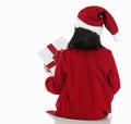 Back of X-mas little girl with huge present Royalty Free Stock Photo