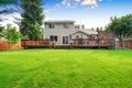 Back yard house exterior with spacious wooden deck Royalty Free Stock Photo