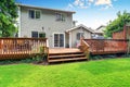 Back yard house exterior with spacious wooden deck Royalty Free Stock Photo