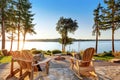 Back yard of waterfront house with adirondack chairs and fire pit Royalty Free Stock Photo