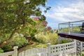 Back yard white fence and deck with water view. Royalty Free Stock Photo