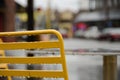 Back of a yellow outdoor chair in a street cafe on Mercer street