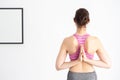 Back of Young beautiful caucasian sporty and active woman in sporty wear doing yoga position and meditating at home in white Royalty Free Stock Photo