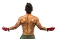 Back of young bodybuilder wearing MMA gloves, with arms spread open Royalty Free Stock Photo