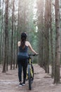 Back young female woman helmet catch bicycle Royalty Free Stock Photo