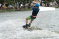 back of the young man wake boarding on a lake with cable in Bangkok Thailand. Concept sport and leisure activities