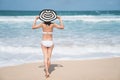 Back of young woman in bikini standing on the beach, Young beautiful woman in bikini swimsuit, tropical island, summer Royalty Free Stock Photo