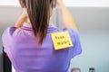 Back of young woman office with a yellow sticky note attached with the text Free Hug. happy april fools day concept Royalty Free Stock Photo