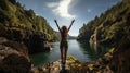 Back of young woman standing on the edge of a cliff with her arms raised. Caucasian female tourist having a great time on her