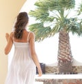 Back of a young woman in a white dress on a vacation Royalty Free Stock Photo