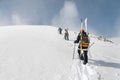 Backcountry climbers, ski climber, walking with skis and snowboard in the mountains. Ski tourism in the alpine landscape