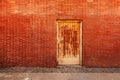 Backdoor, old weathered door and brick wall Royalty Free Stock Photo