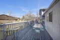 Backdoor veranda of a house with a view of a lawn and nearby building and road