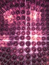 glass bottles with indirect light in purple color, view from below, background and texture