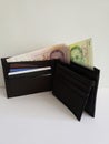 black leather wallet with singaporean banknotes and white background Royalty Free Stock Photo