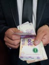 hands a business man counting argentine banknotes