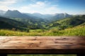 Backdrop of mountains and grass fields behind a wooden table Royalty Free Stock Photo