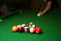 Backdrop of pyramid of pool balls and billiard cues