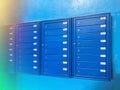 Backdrop of rows of numbered mailbox in modern residential apartments with flare background. Background of blue Mailboxes in an Royalty Free Stock Photo