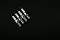 Backdrop with set of spark plugs on black background with copy space. Royalty Free Stock Photo