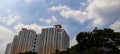 the backdrop of the view of the towering apartment building with the sunny weather