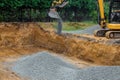 Backfilling trench for the stones gravel at construction site in excavator backfill of foundation