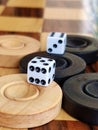 Wooden backgammon board game of pearl inlaid on brown background.