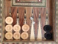 Wooden backgammon board game of pearl inlaid on brown background.