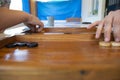 Backgammon game. The player`s hand moves the chip, closeup Royalty Free Stock Photo