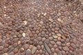 Earth tones oval pebbles road in historic Italian town