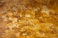 High res close up smooth spotted multi toned yellow and siena colored old stucco wall