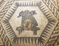 Detailed close up of a roman mosaic with a centered head surrounded by geometrical shapes
