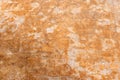 old grunge, rough and weathered pale orange stone wall with visible cracks close up background