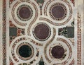 antique weathered close up of pale and multi color geometrically intricate patterned marble mosaic tile floor background