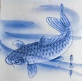 close up of square traditional Tobeyaki cream ceramic tile with a indigo blue carp in the water design background