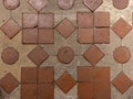 geometrical square light cream with geometrical dark brown pale terracotta tiles background floor close up