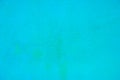 close up of neon bright semi smooth Robin\'s Egg Blue stucco wall texture background