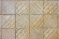 geometrical square light cream with sideways lines terracotta tiles background floor close up